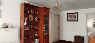 a room with a wooden book shelf filled with items at EL ENSUEÑO in Lima