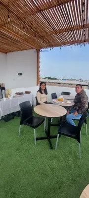 a man and woman sitting at a table in a restaurant at Mandala in Pisco