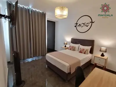 a bedroom with a bed and a table in a room at Mandala in Pisco