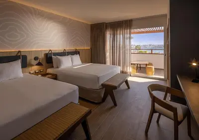 a hotel room with two beds and a balcony at Aranwa Paracas Resort & Spa in Paracas