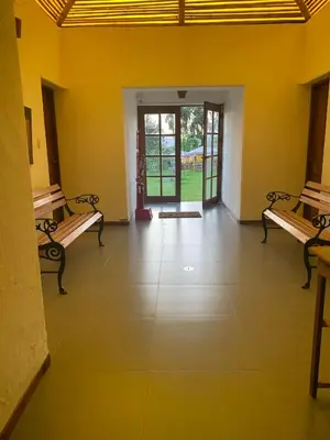 a room with two benches and a hallway with doors at Bungalows de Casa Verde in Mala
