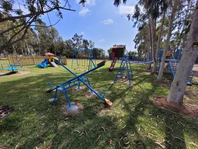 a park with a playground with slides and swings at Bungalows de Casa Verde in Mala