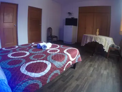a bedroom with a bed with a red and blue blanket at Waldorf in Lima