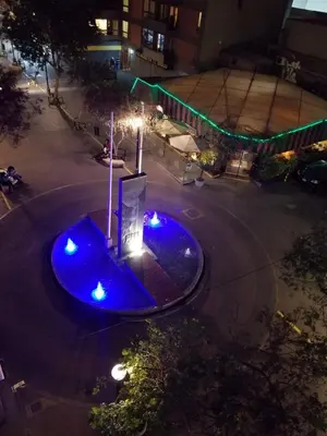 an empty street at night with blue lights at Waldorf in Lima