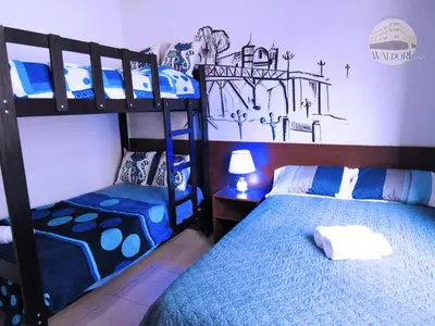 a bedroom with two bunk beds and a lamp at Waldorf in Lima