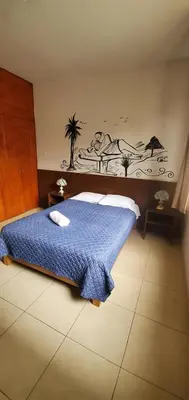 a bedroom with a bed with a blue blanket at Residencial Waldorf in Lima