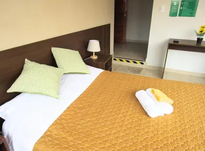 a bedroom with a large bed with towels on it at Residencial Waldorf in Lima