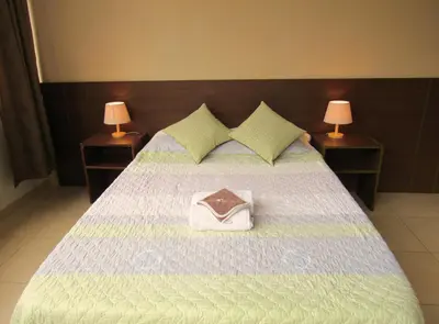 a bedroom with a bed with a purse on it at Residencial Waldorf in Lima