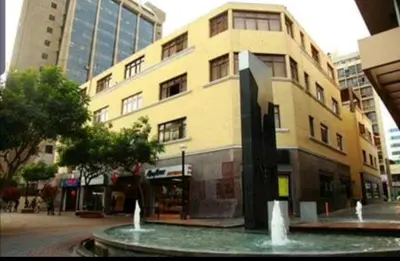 a large building with a fountain in front of it at Residencial Waldorf in Lima