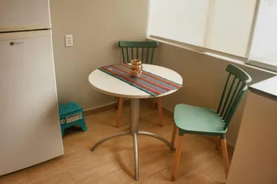 a small kitchen with a table and two chairs at Lindo y moderno Excelente ubicación in Lima