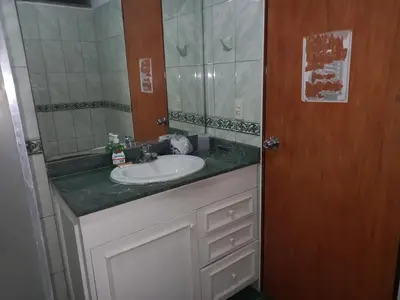 a bathroom with a sink and a mirror at suite pardo CAA Miraflores in Lima