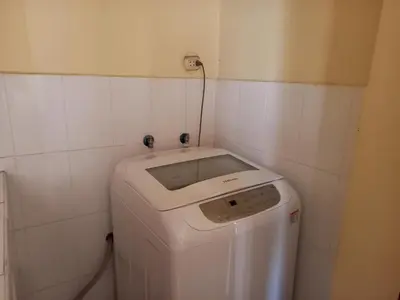 a washer and dryer in a corner of a bathroom at suite pardo CAA Miraflores in Lima