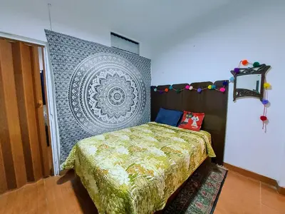 a bedroom with a bed and a large wall at Cozy and fully furnished apartment in Miraflores in Lima