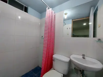 a bathroom with a toilet and a sink at Cozy and fully furnished apartment in Miraflores in Lima
