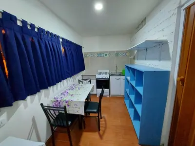 a kitchen with a table and chairs and a blue cabinet at Cozy and fully furnished apartment in Miraflores in Lima
