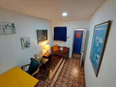 a living room with a table and chairs and a blue door at Cozy and fully furnished apartment in Miraflores in Lima