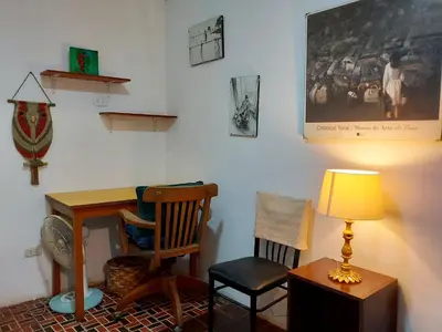 a room with a desk and a chair and a lamp at Cozy and fully furnished apartment in Miraflores in Lima