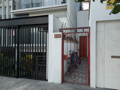 a building with a gate with bikes parked outside at Cozy and fully furnished apartment in Miraflores in Lima