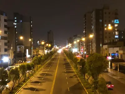 a city street at night with street lights at Habitación RRB in Lima