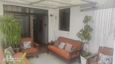 a porch with two chairs and a couch at Habitación RRB in Lima