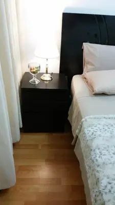 a bedroom with a bed and a table with a lamp at Habitación RRB in Lima