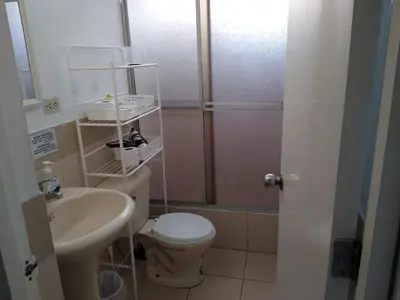 a bathroom with a toilet and a sink and a shower at Habitación RRB in Lima
