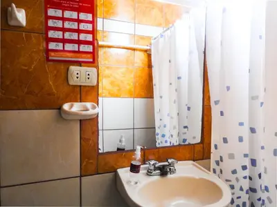 a bathroom with a sink and a mirror at Hostal Encanto Machupicchu in Machu Picchu