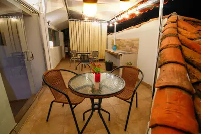 a glass table and chairs in a room at CASONA TORDO - A 3 Cdras de la Plaza - Habitaciones con baño privado in Cusco