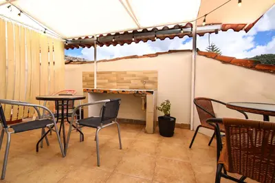 a patio with two tables and chairs and a fire place at CASONA TORDO - A 3 Cdras de la Plaza - Habitaciones con baño privado in Cusco