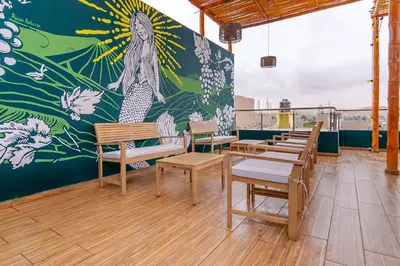 a room with benches and a mural on the wall at Hospedaje Muñoz in Ica