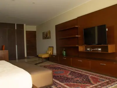 a hotel room with a bed and a flat screen tv at Hotel & Hacienda La Caravedo in Ica