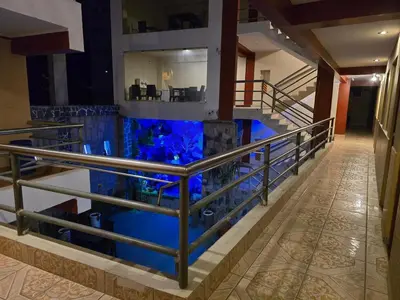 a lobby with a staircase with blue water at Hotel Manantial in Churín