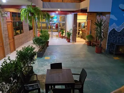 an empty lobby with tables and chairs in a building at Hotel Manantial in Churín