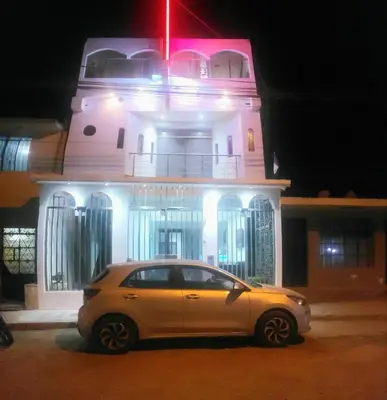 a car parked in front of a building at night at Hospedaje Pueblo Viejo in Casa Blanca