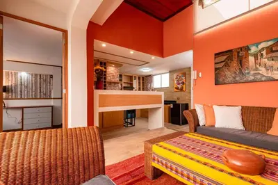 a living room with orange walls and a couch at luxury Andino Ciudad real & 1 bed in Lima