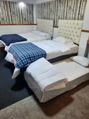 three beds sitting in a room with at luxury Andino Ciudad real & 1 bed in Lima