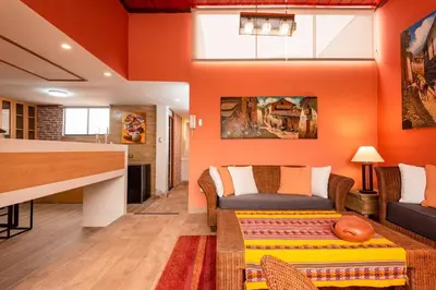a living room with orange walls and a couch at luxury Andino Ciudad real & 1 bed in Lima