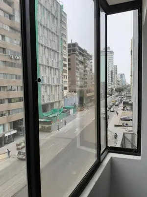 a view of a city street from a window at Miraflores Kennedy's Park Apartment in Lima