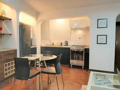 a kitchen with a table and chairs in a room at Miraflores Kennedy's Park Apartment in Lima