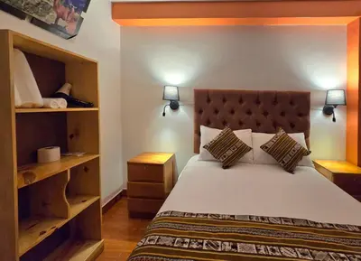 a bedroom with a large bed with two pillows at Amakonkay Machupicchu in Machu Picchu