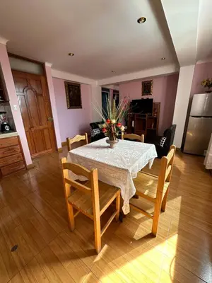 a dining room with a table and some chairs at Departamento Don Santiago Centro in Cusco