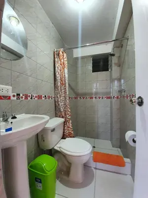 a bathroom with a toilet and a sink and a shower at Departamento Don Santiago Centro in Cusco