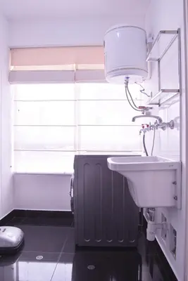 a bathroom with a white sink and a window at KYRA APARTMENTS - Central Miraflores - Spacious 4BR for 07 guests in Lima