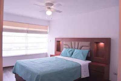 a bedroom with a bed and a ceiling fan at KYRA APARTMENTS - Central Miraflores - Spacious 4BR for 07 guests in Lima