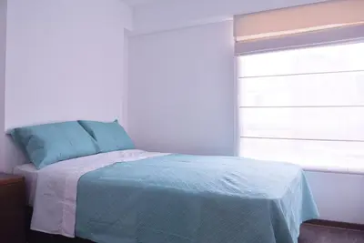 a bedroom with a bed and a window at KYRA APARTMENTS - Central Miraflores - Spacious 4BR for 07 guests in Lima