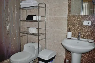 a bathroom with a toilet and a sink at Apartamentos Las Americas in Lima