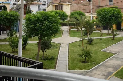 a view of a park with trees and a sidewalk at Apartamentos Las Americas in Lima
