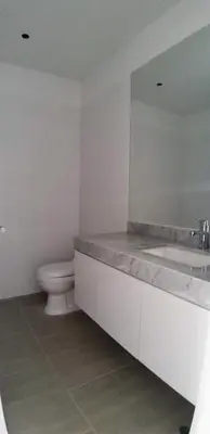 a bathroom with a toilet and a sink and a mirror at Vive - Descansa - Disfruta in San Bartolo