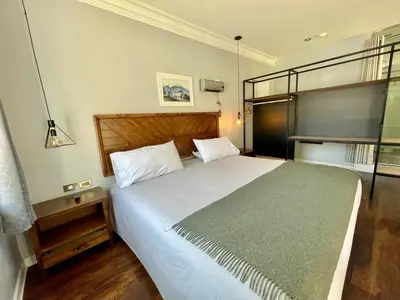 a bedroom with a large white bed in a room at Casa Montes San Blas in Cusco