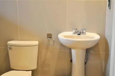 a bathroom with a toilet and a sink at Hotel Choquequirao in Cusco